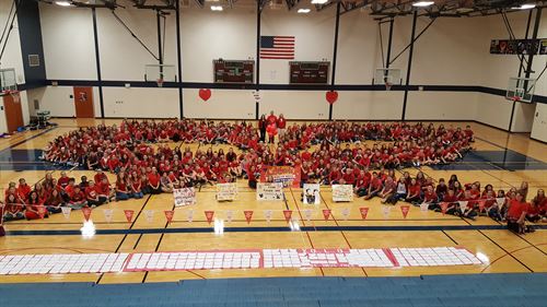 students forming red ribbon for Red Ribbon Day 2016